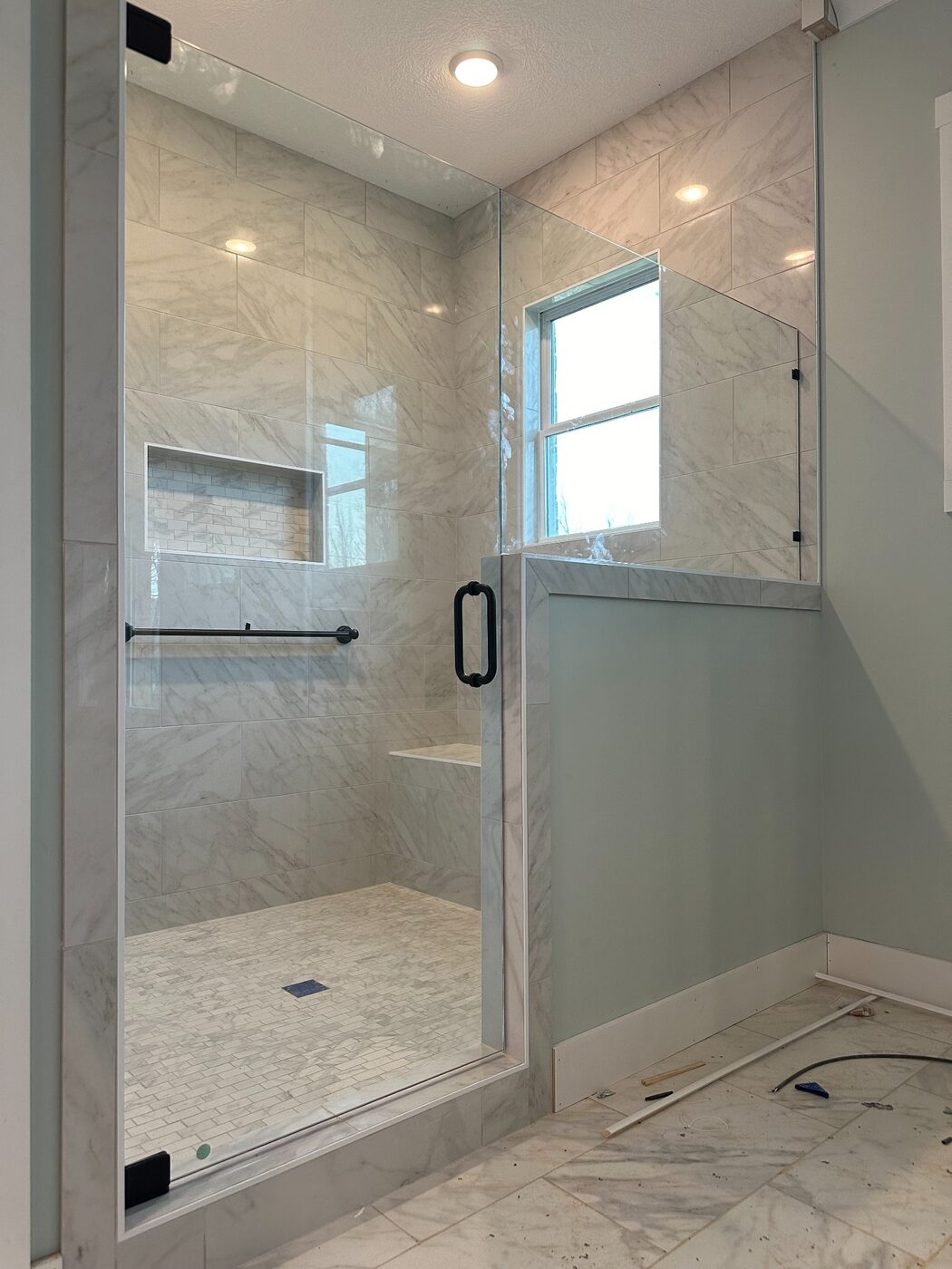 Custom frameless shower door and fixed panel